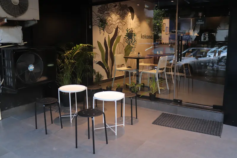 Tables outside the glass front in the evening